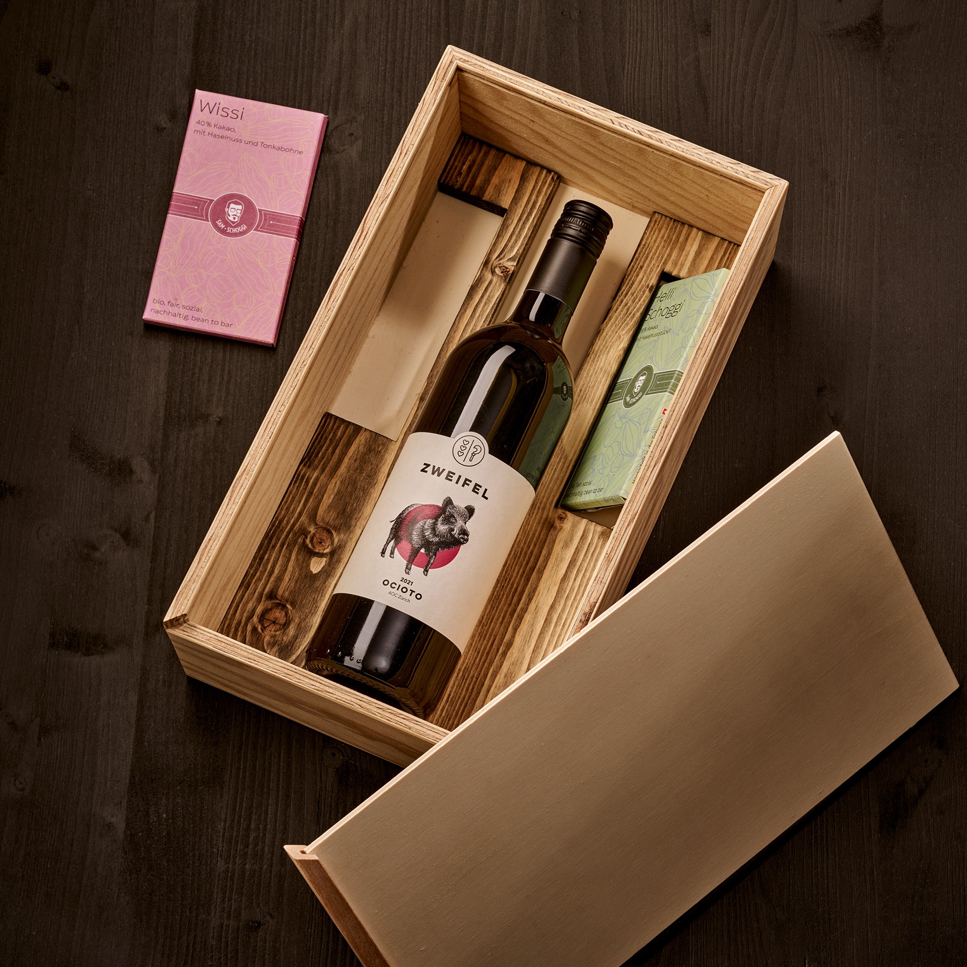 Holzkiste mit Schokolade und Wein